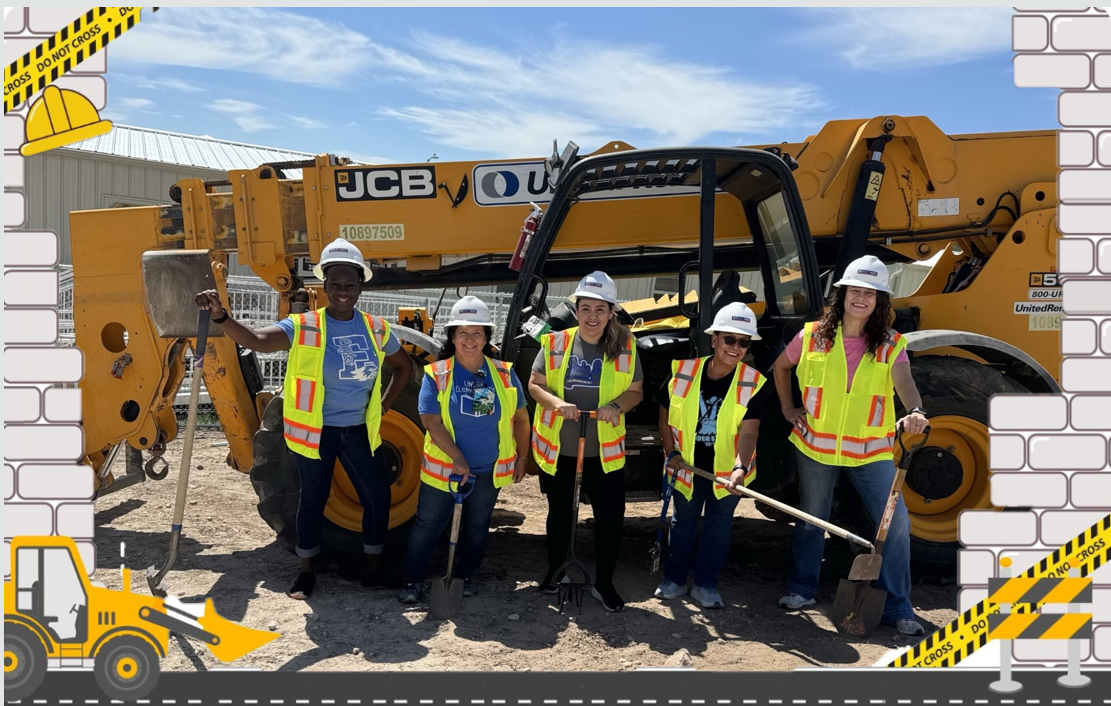 Picture of teachers in a construction site holding shovels in front of heavy-duty construction equipment.